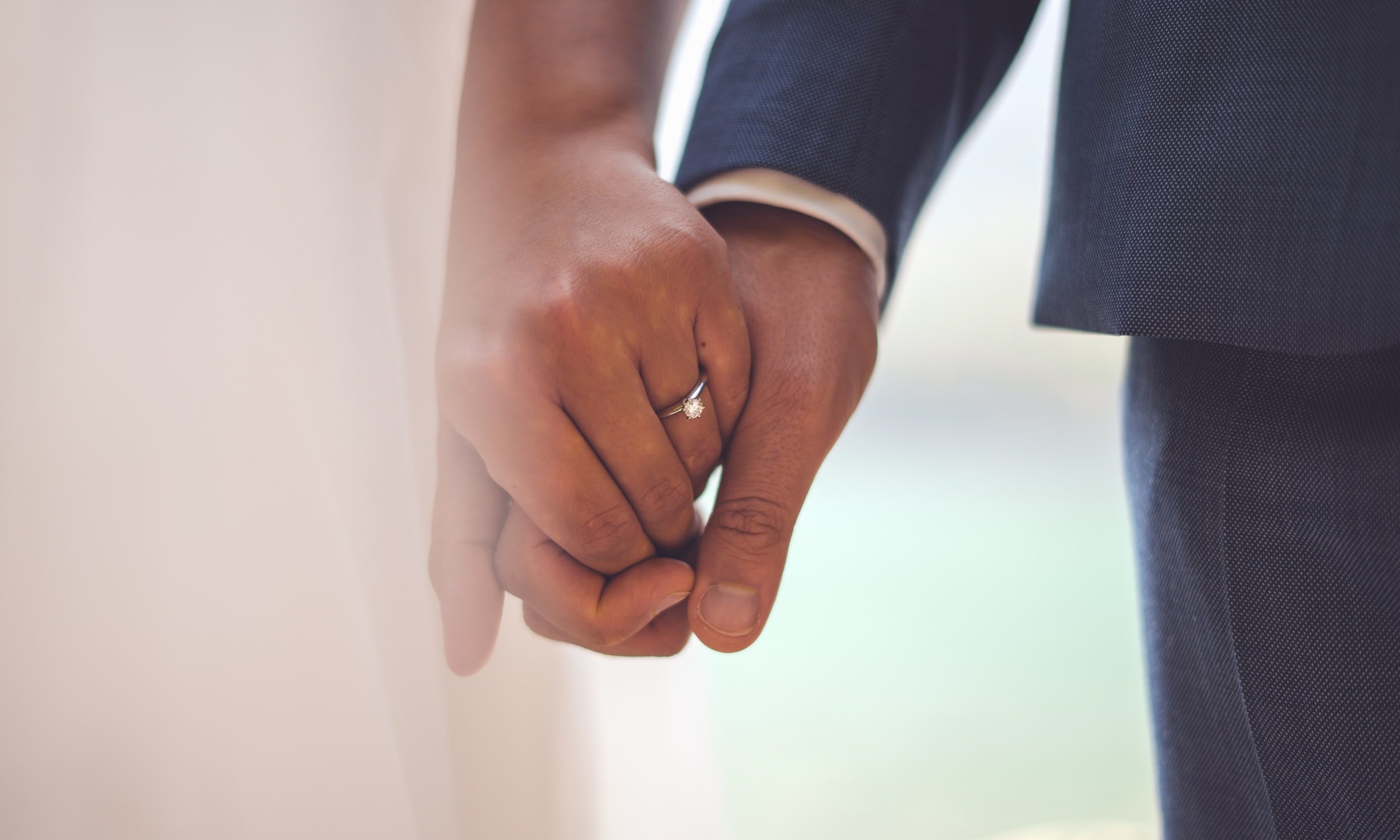 Couple hold hands to get married.