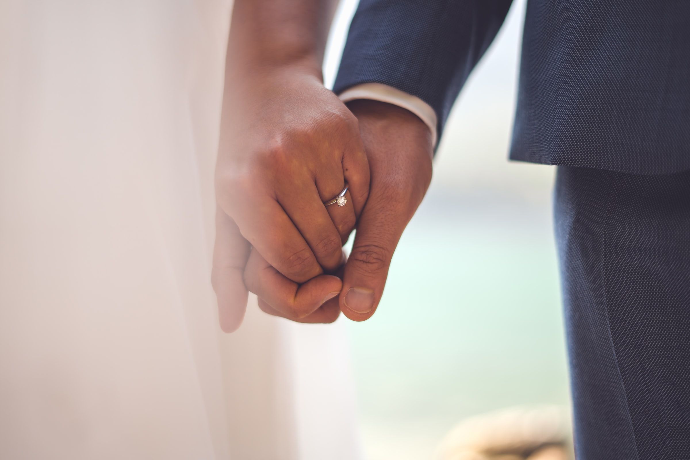 Couple hold hands to get married.