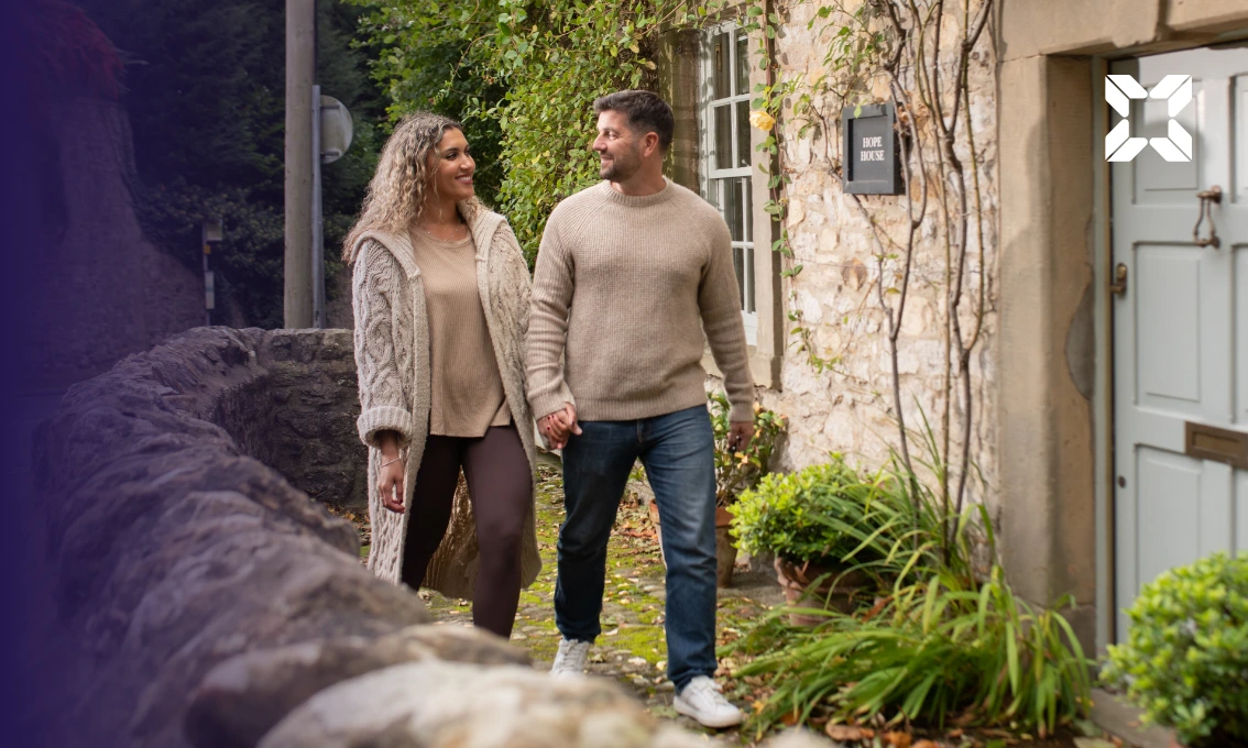 A young couple about to walk into a house