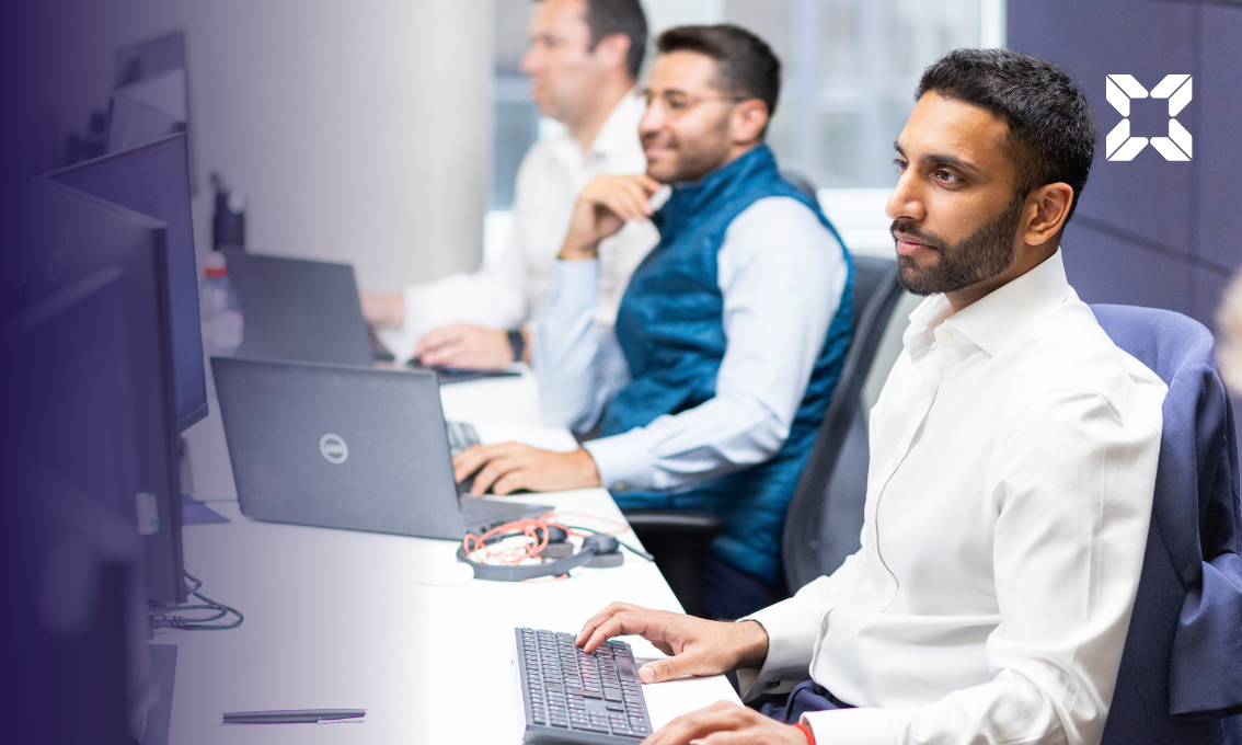 Three financial advisers looking at computer screens